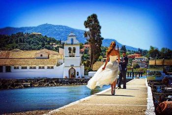 The bride walks to the church overlooking the Pontikonissi